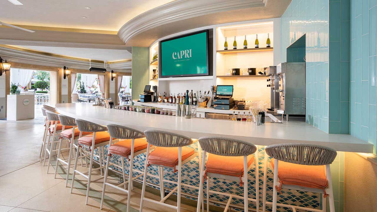 An outside bar with high-top chairs.